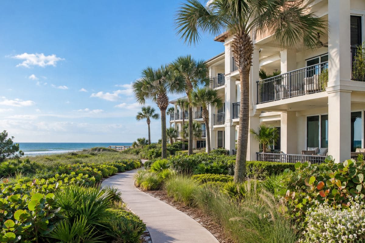 Coastal condominium community with palms and native landscaping